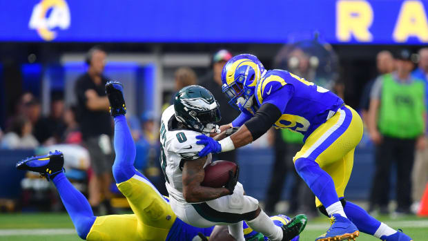 Oct 8, 2023; Inglewood, California, USA; Philadelphia Eagles running back D'Andre Swift (0) is brought down by Los Angeles Rams defensive tackle Aaron Donald (99) during the second half at SoFi Stadium. Mandatory Credit: Gary A. Vasquez-USA TODAY Sports